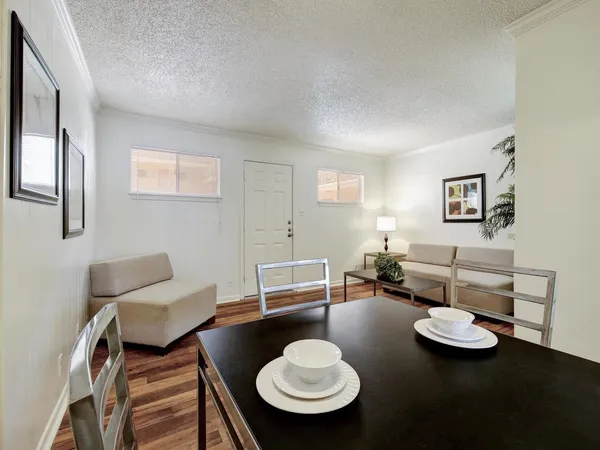 a living room with furniture and a wooden floor