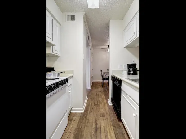 a view of a kitchen from the hallway