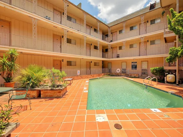 a view of a swimming pool with a lounge chairs