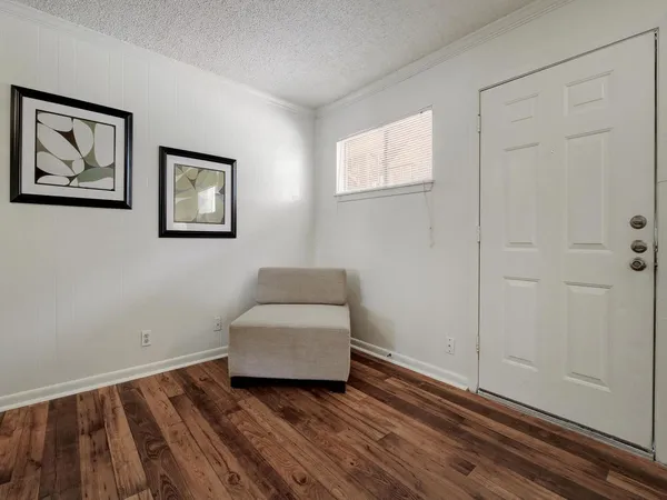 a room with painting on the wall and a window