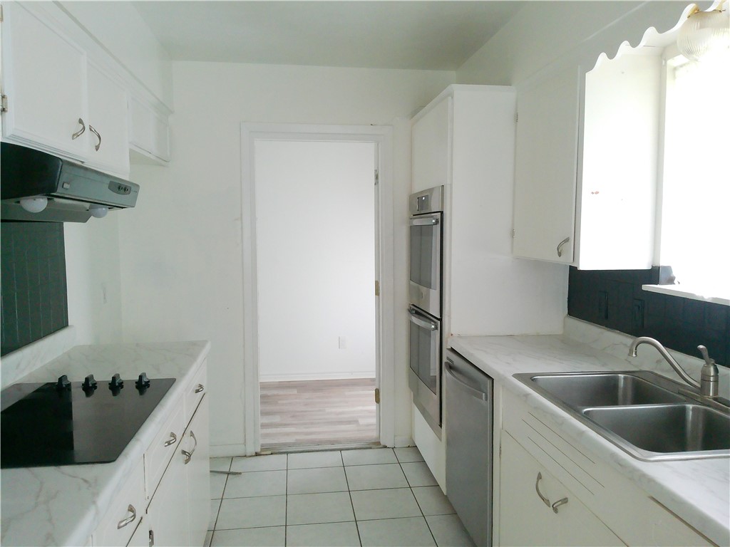 4117 Monaco Street Corpus Christi, TX 78411 - Photo 7 of 17 a kitchen with a sink and refrigerator