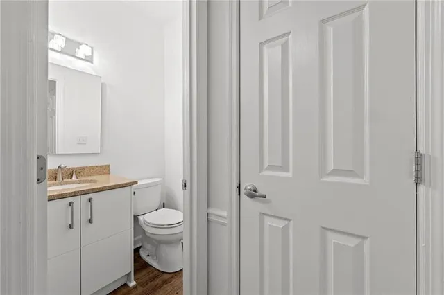 a bathroom with a toilet a sink and a mirror
