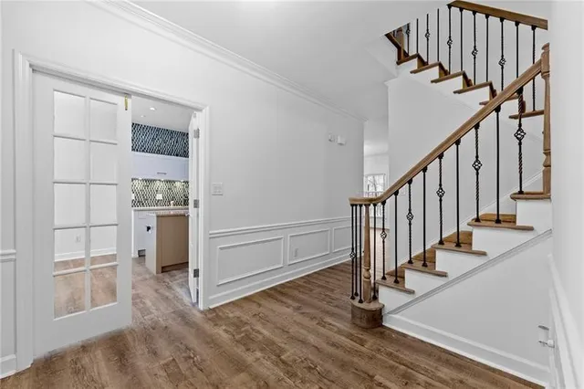 a view of entryway and hall with wooden floor