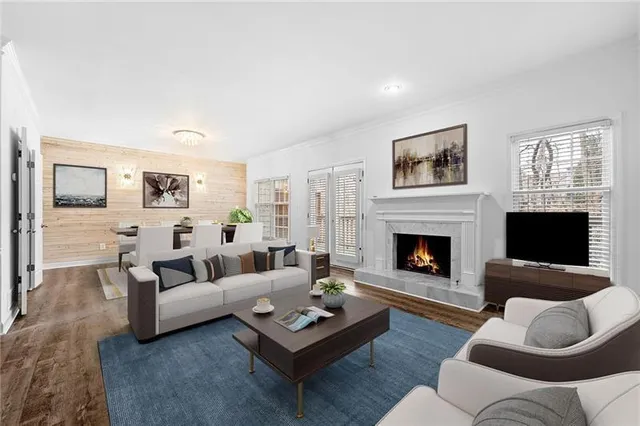 a living room with furniture flat screen tv and a fireplace