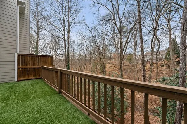 a view of a balcony with yard