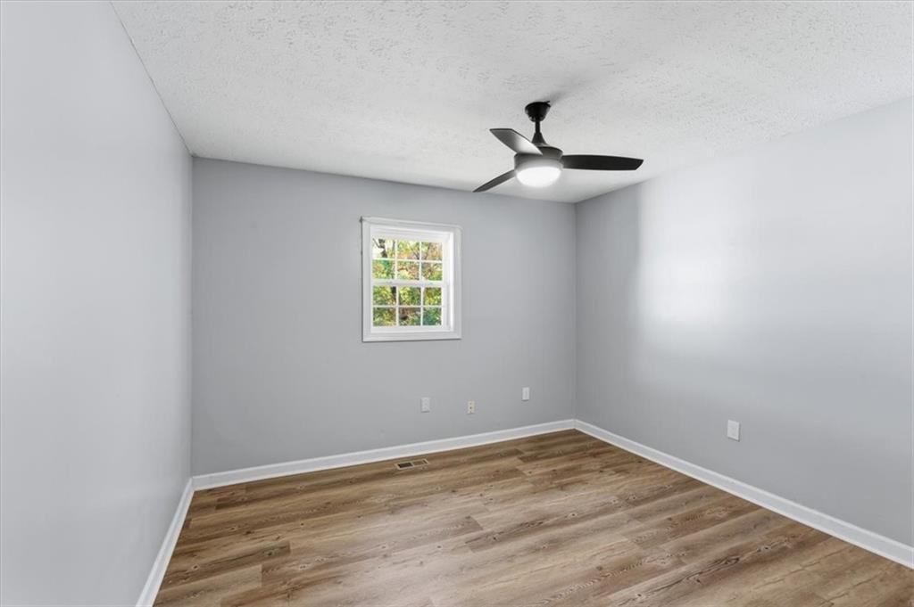 1500 Moores Ferry Road Southwest Plainville, GA 30733 - Photo 28 of 33 wooden floor in an empty room with a window