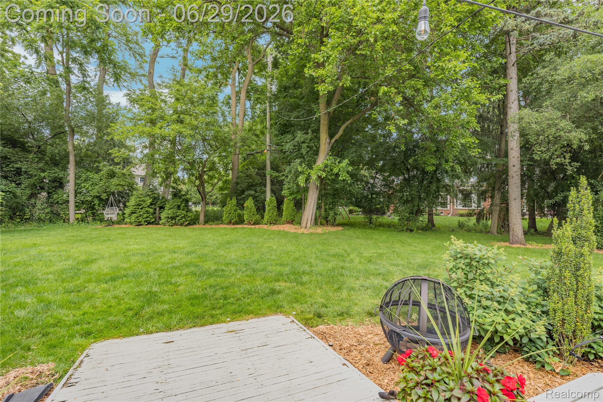 6085 Worlington Road Bloomfield Hills, MI 48301 - Photo 60 of 75 Spacious outdoor area featuring a wood-finish patio, extensive green lawn, and mature trees