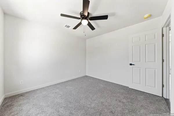 a view of room with a ceiling fan