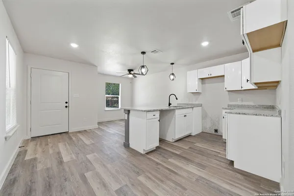 a kitchen with a white wooden cabinets and white appliances