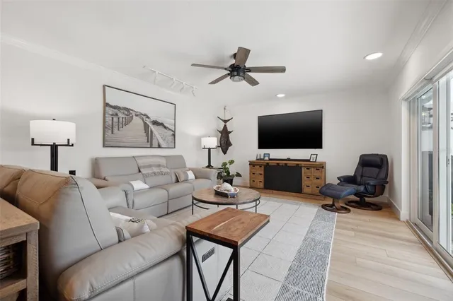 a kitchen with stainless steel appliances granite countertop a stove a refrigerator a sink a dining table and chairs with wooden floor