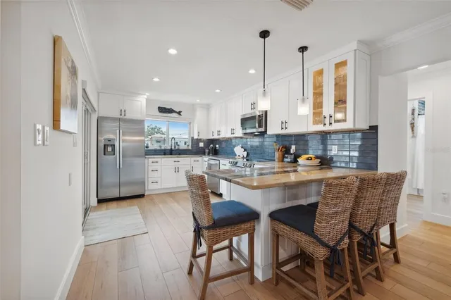 a kitchen with a stove a sink and a microwave