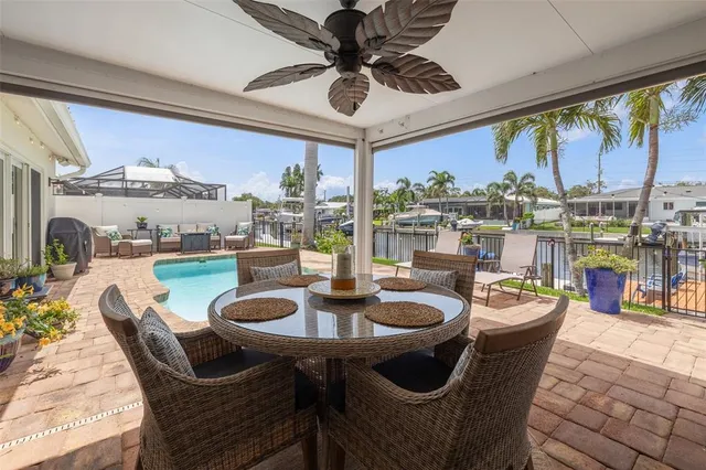 a kitchen with stainless steel appliances granite countertop a stove a sink a refrigerator and a microwave