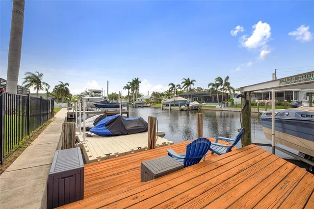 a swimming pool with outdoor seating and yard