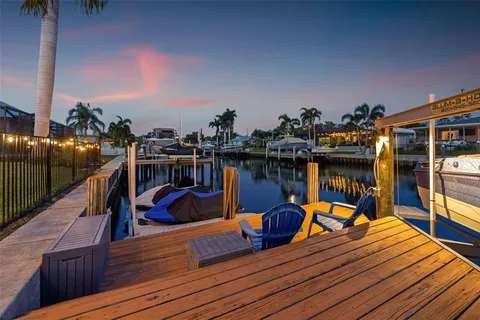 a view of a house with a yard and potted plants