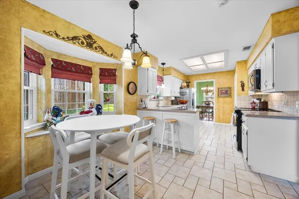 a view of a dining room with furniture window and outside view