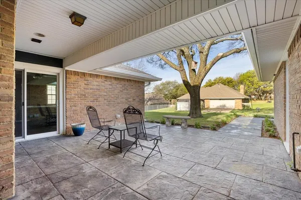 a view of a patio with table and chairs and potted plants