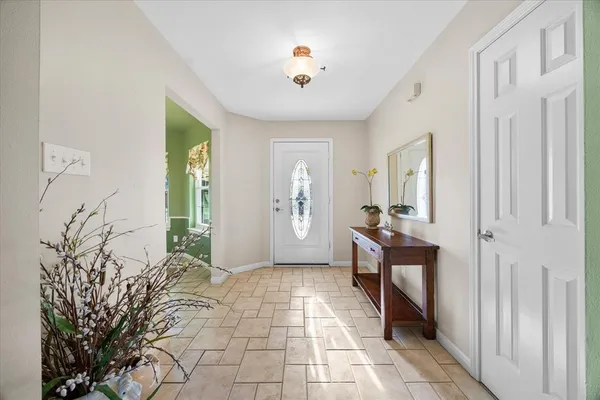 a view of a hallway to a livingroom with furniture and front door