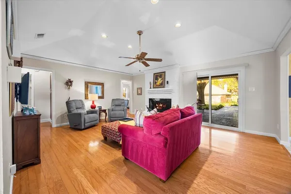 a living room with furniture window and a wooden floor