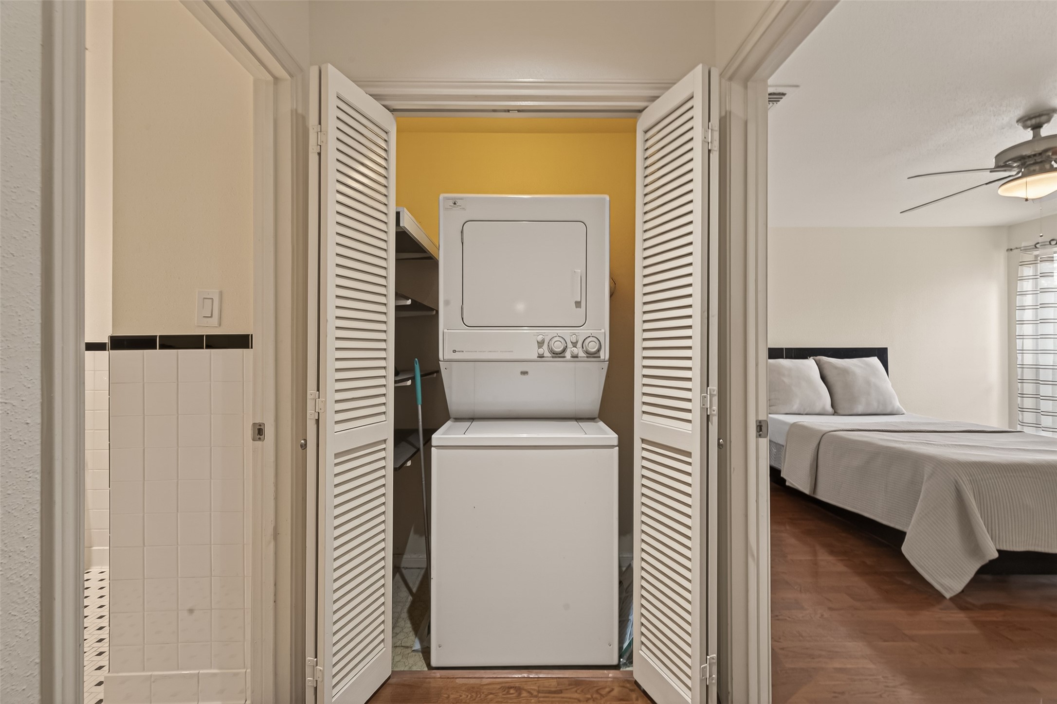2829 Timmons Lane, Unit 144 Houston, TX 77027 - Photo 24 of 41 Compact laundry area with a stacked washer and dryer.