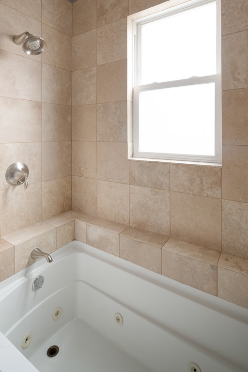 295 D Street, Unit 1 Boston, MA 02127 - Photo 9 of 13 a bathroom with a bathtub and window