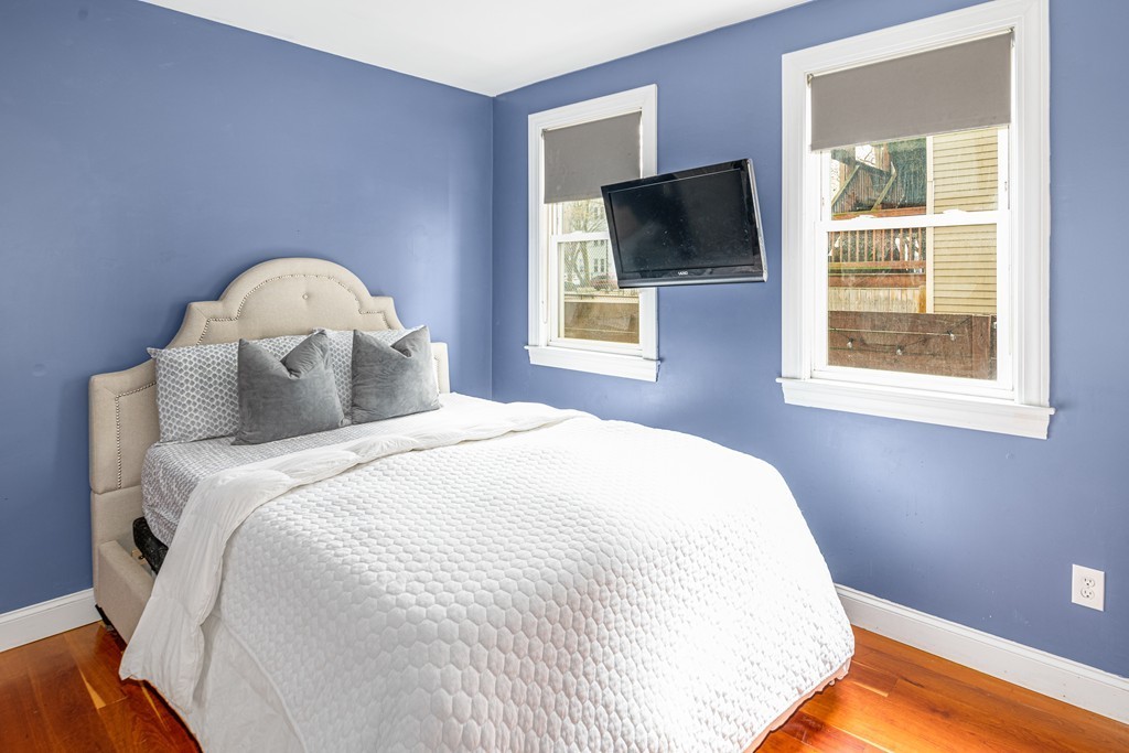 295 D Street, Unit 1 Boston, MA 02127 - Photo 10 of 13 a bedroom with a bed and a flat tv screen on dresser