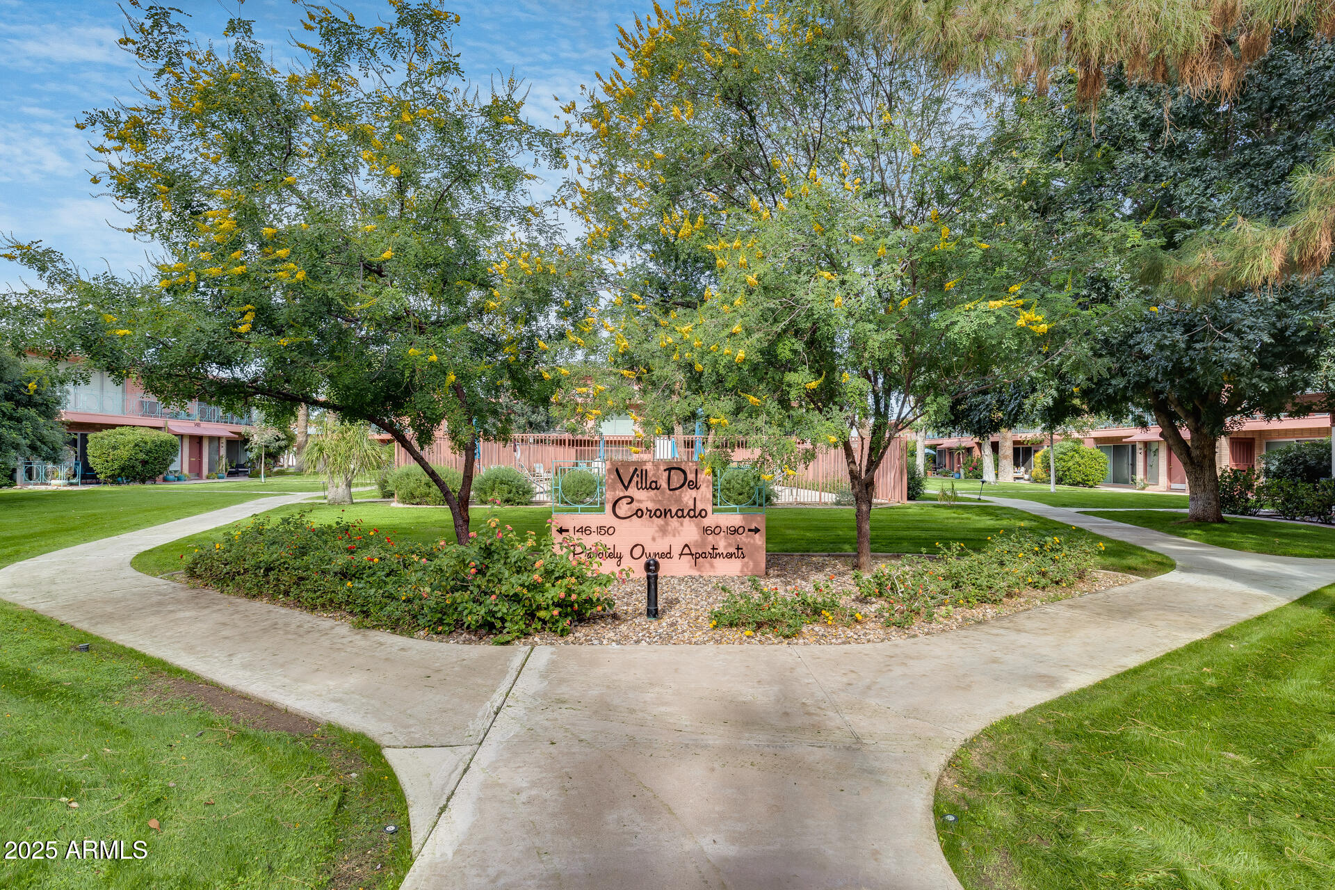 a front view of a house with a yard and fountain