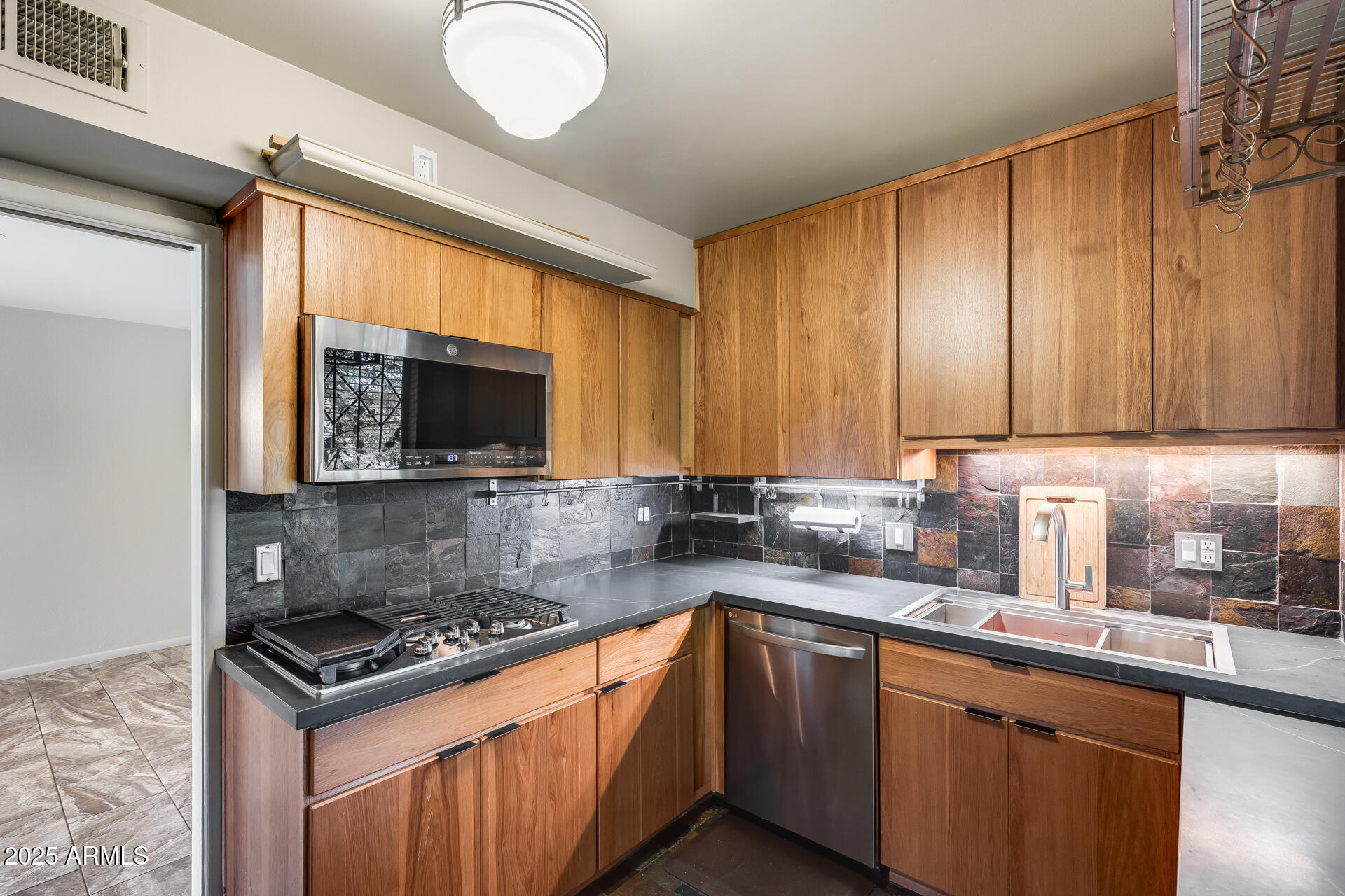 146 East Coronado Road, Unit 40 Phoenix, AZ 85004 - Photo 14 of 39 a kitchen with stainless steel appliances granite countertop a sink stove and microwave