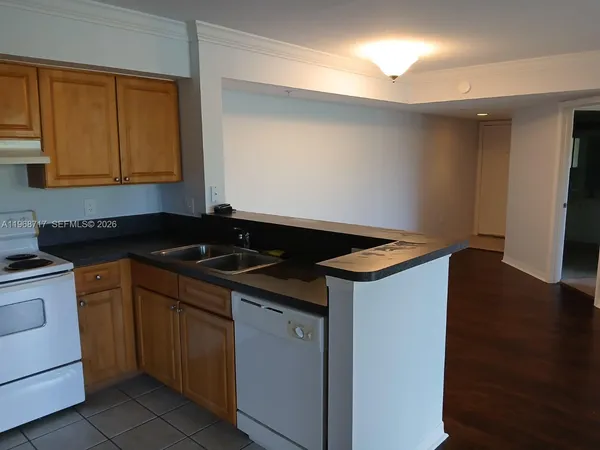 a kitchen that has a sink and a stove