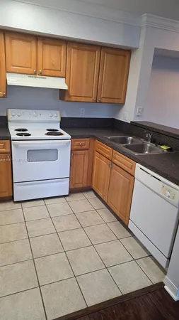 a kitchen with a stove top oven cabinets and a stove top oven