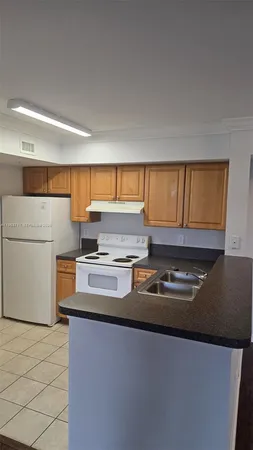a kitchen with stainless steel appliances granite countertop a sink and a stove