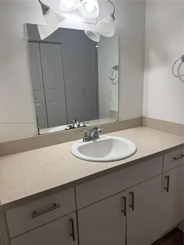 a bathroom with a sink and a mirror
