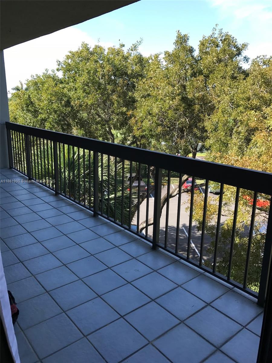8811 Southwest 132nd Place, Unit 401CW Miami, FL 33186 - Photo 8 of 10 a balcony with outdoor space