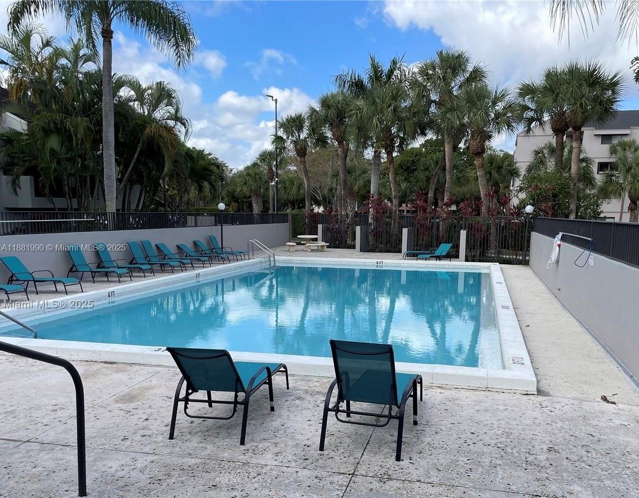 8811 Southwest 132nd Place, Unit 401CW Miami, FL 33186 - Photo 9 of 10 a view of a chairs and table in patio