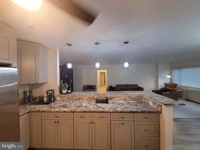 a kitchen with granite countertop a sink and cabinets