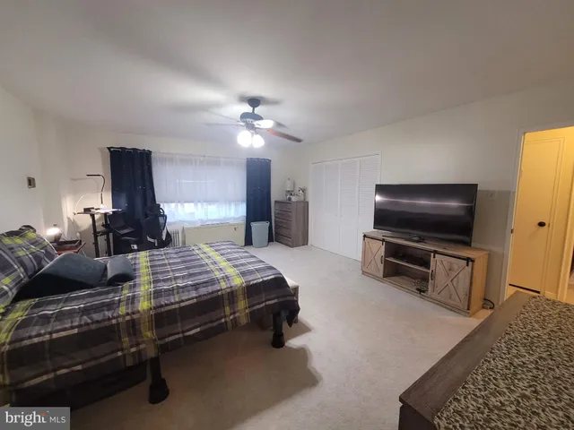 a bedroom with furniture and a flat screen tv