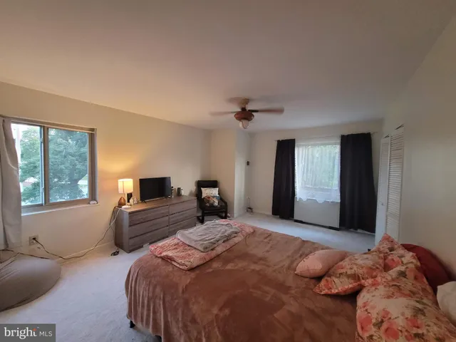 a bedroom with a large bed and a window