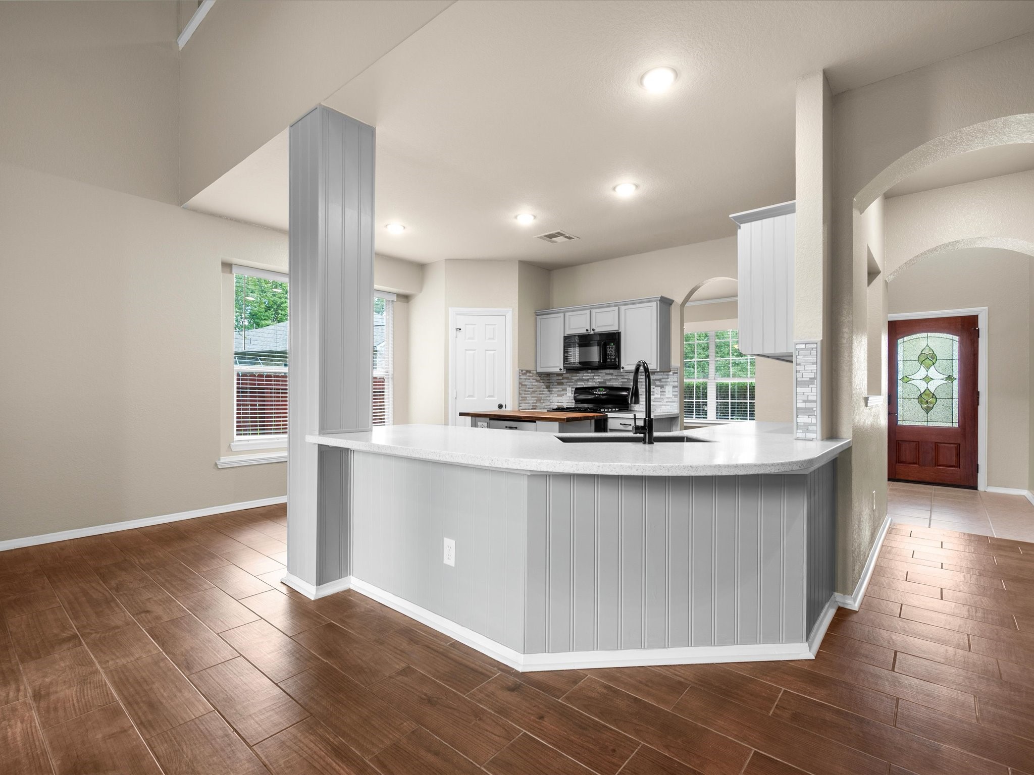 291 Sunset Path South Conroe, TX 77316 - Photo 10 of 39 The updated kitchen features new HI-MACS countertops & breakfast bar, with an open design that connects seamlessly to the family room.