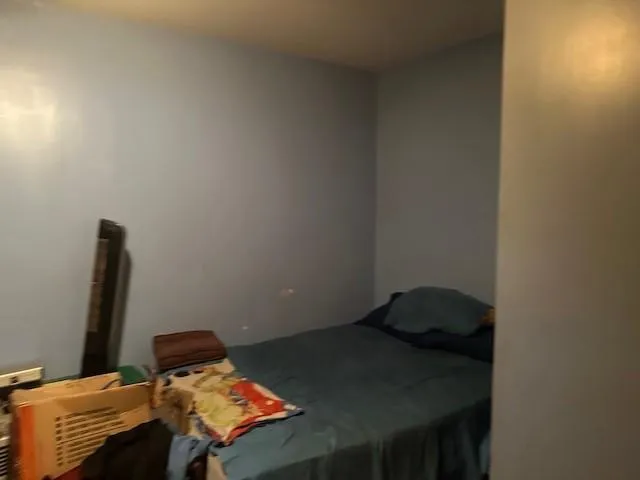 a bed sitting in a bedroom next to a window