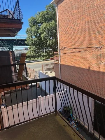 a view of balcony with wooden floor