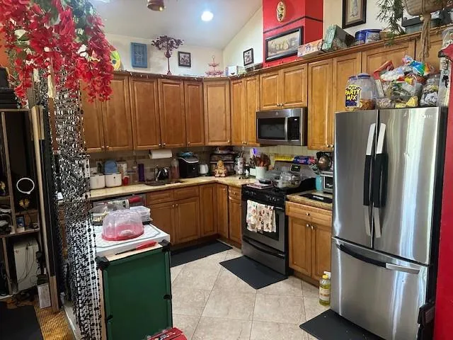 a kitchen with a refrigerator sink and cabinets