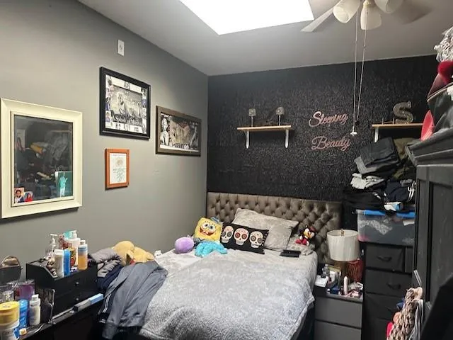 a bedroom with a bed and the lamp