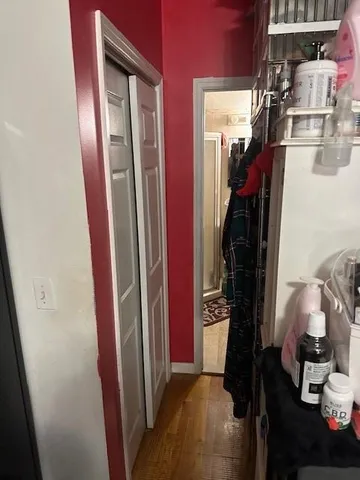 a view of walk in closet with clothes and shoes