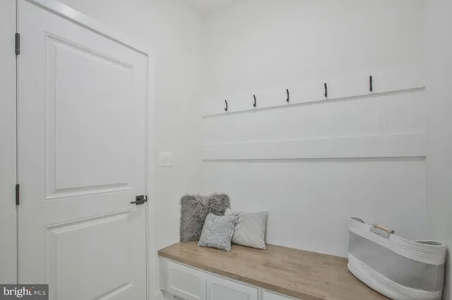 a kitchen with stainless steel appliances granite countertop a stove a refrigerator a kitchen island a stove a sink a dining table and chairs with wooden floor