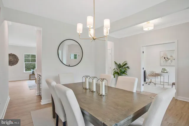 a view of a hallway with furniture and a window