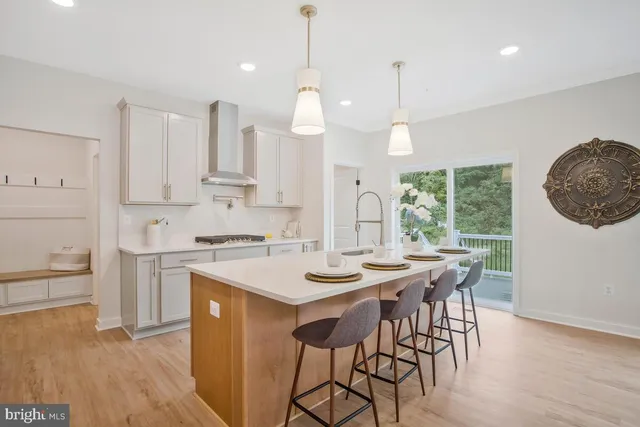 a view of a dining room with furniture a fireplace and wooden floor