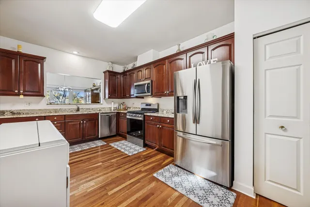 a kitchen with stainless steel appliances granite countertop a refrigerator sink and cabinets