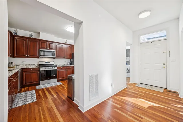 a kitchen with stainless steel appliances granite countertop a refrigerator stove and oven