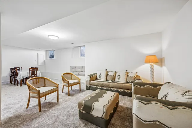 a living room with furniture and a chair