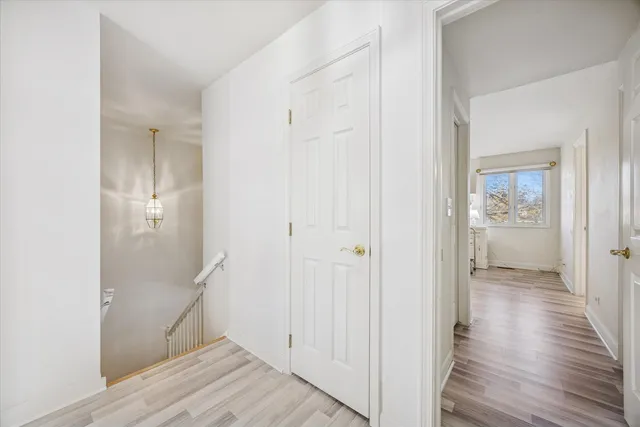 a bedroom with a bed a dresser and chair