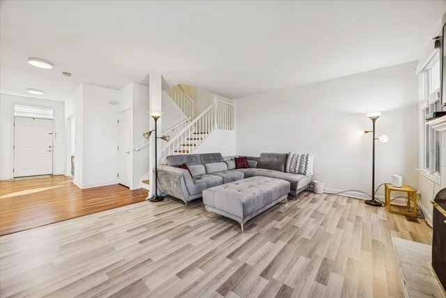 a spacious bedroom with a bed and a wooden floor